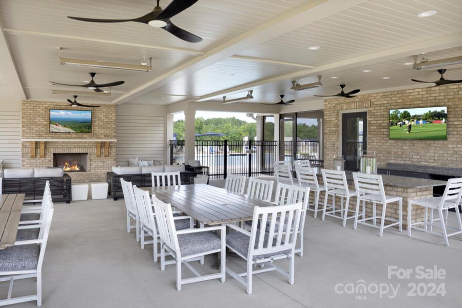 HUGE Covered Porch with outdoor kitchen area, gas grills, fireplace, heaters and fans for a year round experience.