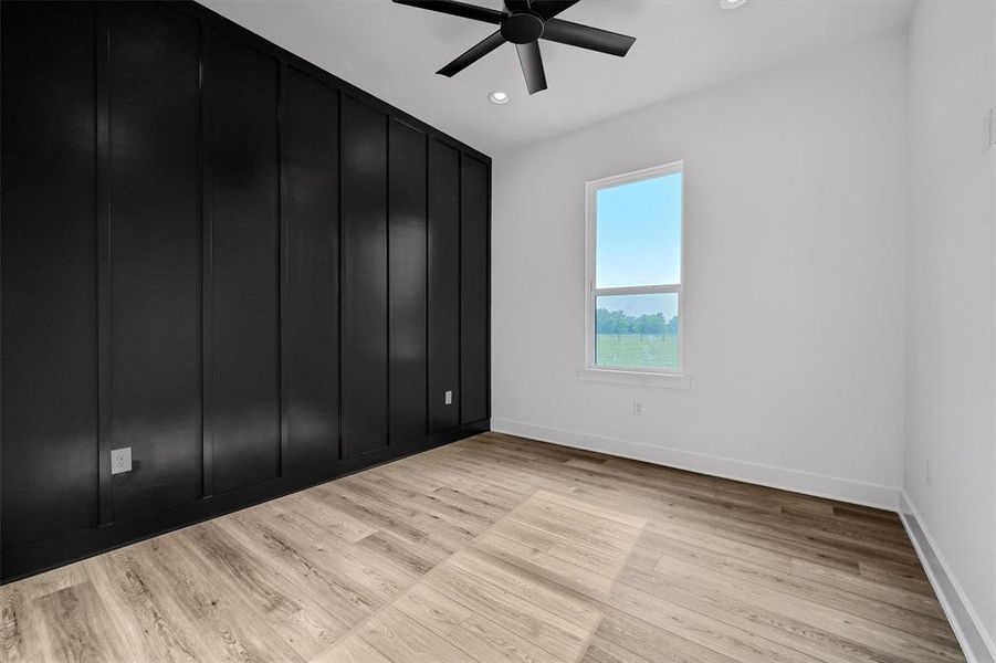 Unfurnished room with light wood-type flooring and ceiling fan