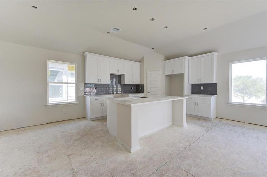 Imagine preparing meals in this spacious, light-filled kitchen, designed with both style and efficiency in mind. With room for a central island and abundant storage, this kitchen will be a chef’s dream. **This image is from another Saratoga Home - Artemis floorplan.**