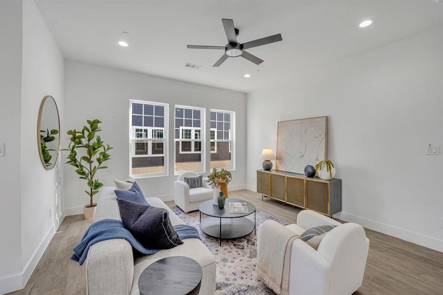 Living room featuring hardwood / wood-style floors and ceiling fan