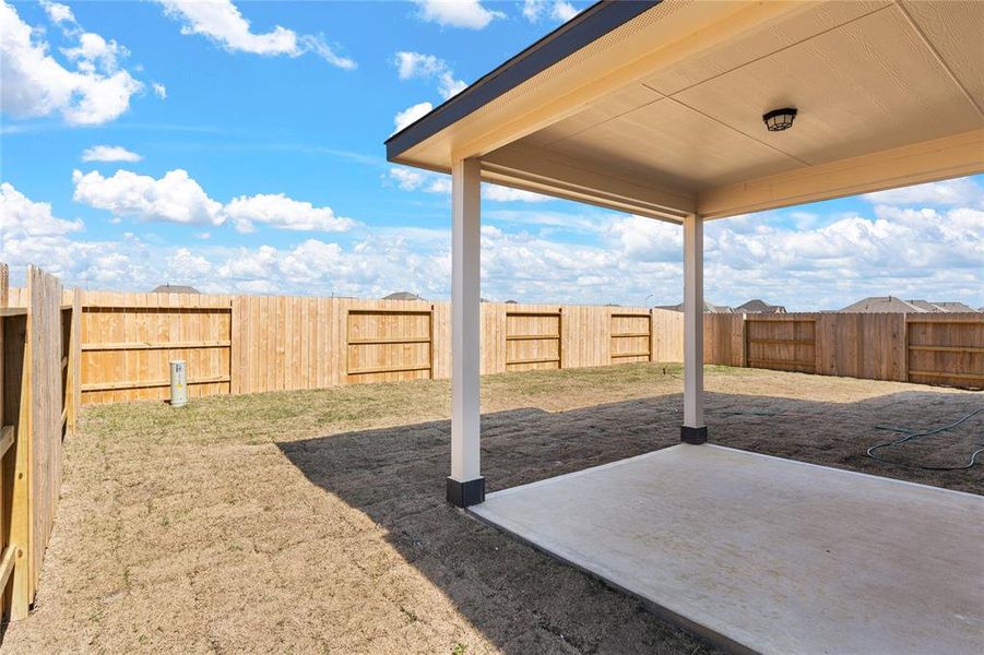 The covered patio is generously sized, providing ample space for various outdoor activities.