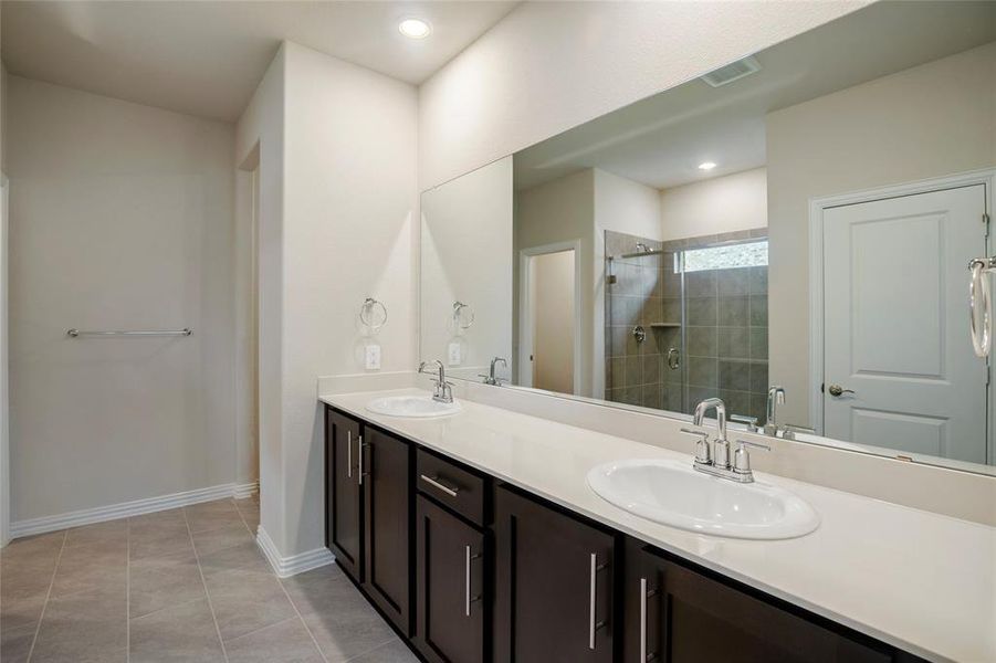 Primary bathroom with dual sinks and a large counter