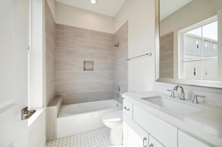 En suite bathroom with large window providing natural light.