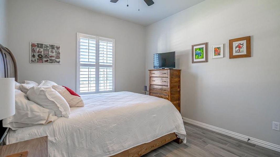 Bedroom with wood-type flooring and ceiling fan