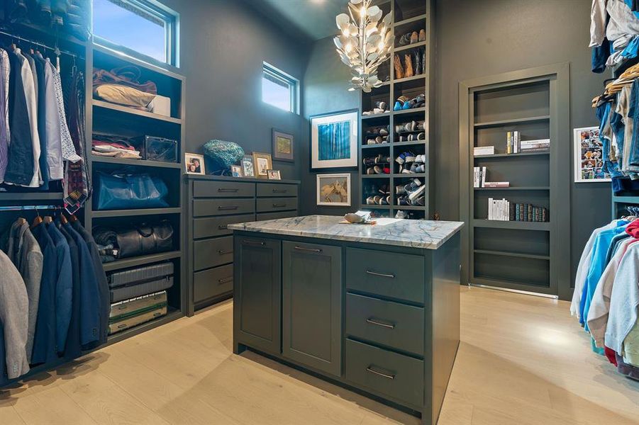 The other side of the bathroom also provides its own spacious vanity area and opens into this second custom built walk-in closets. The bookcase on the back wall opens into your own private bonus retreat room.