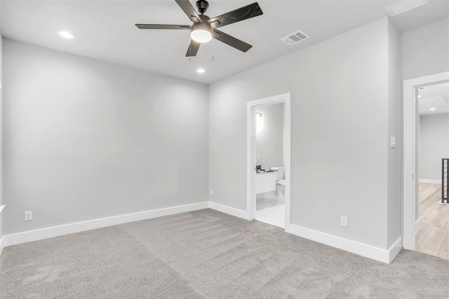 Carpeted spare room with ceiling fan