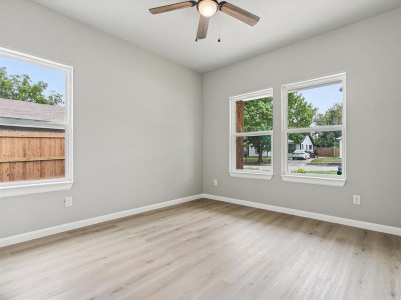 Spare room featuring light wood-type flooring and ceiling fan