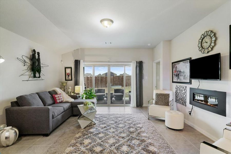 Family room off the kitchen and dining space. Tile floors, and covered entertaining patio.