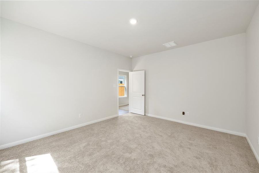 The primary bedroom, ready for a king-sized bed and nightstands!