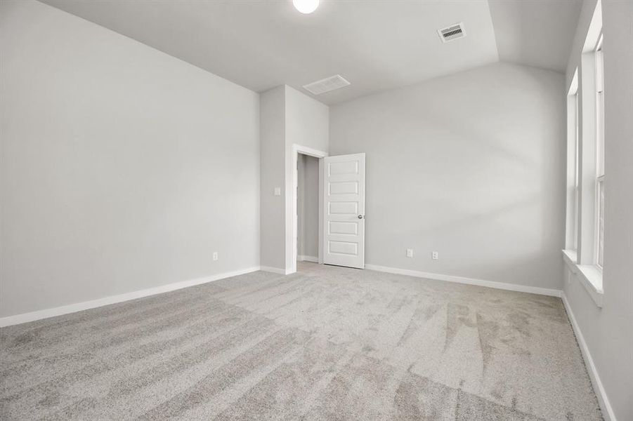 Come decompress in the stunning primary suite after a lengthy day! Experience the luxury of plush carpeting, warm paint hues, high ceilings, and large windows featuring privacy blinds. Sample photo of completed home with similar floor plan. As-built interior colors and selections may vary.