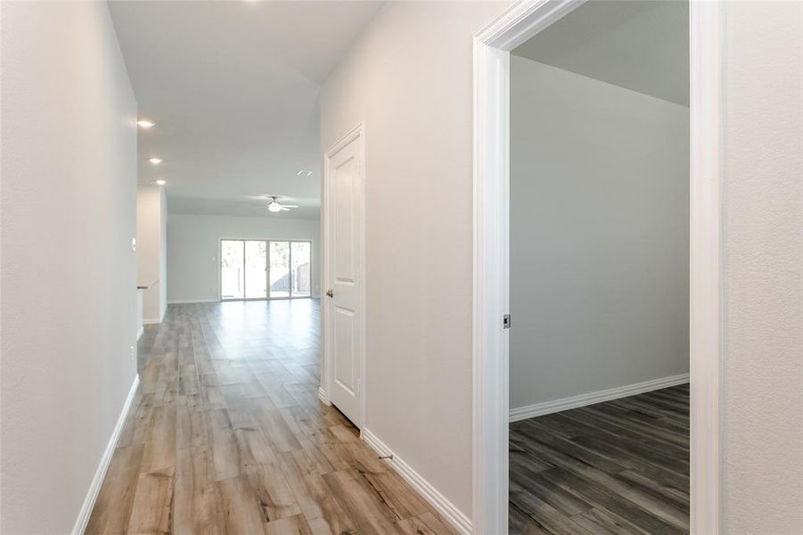 Corridor featuring wood-type flooring