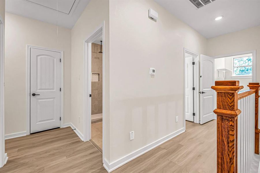 Second floor landing with access to the laundry room and bedrooms.