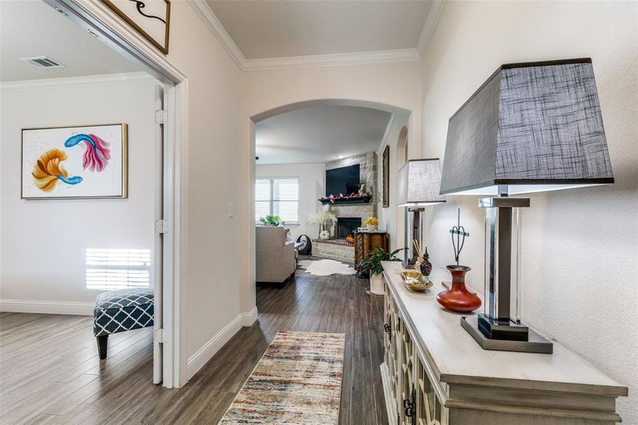 Corridor featuring dark hardwood / wood-style floors and crown molding