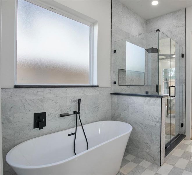 Bathroom with separate shower and tub and tile walls