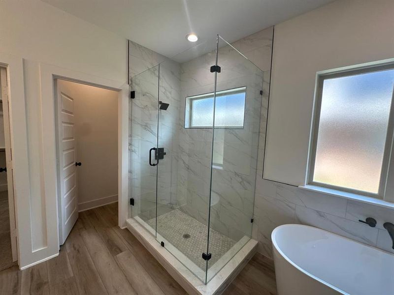 Bathroom featuring plus walk in shower, a wealth of natural light