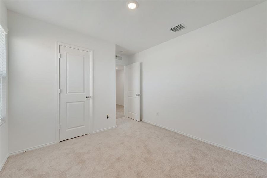 Unfurnished bedroom featuring light carpet