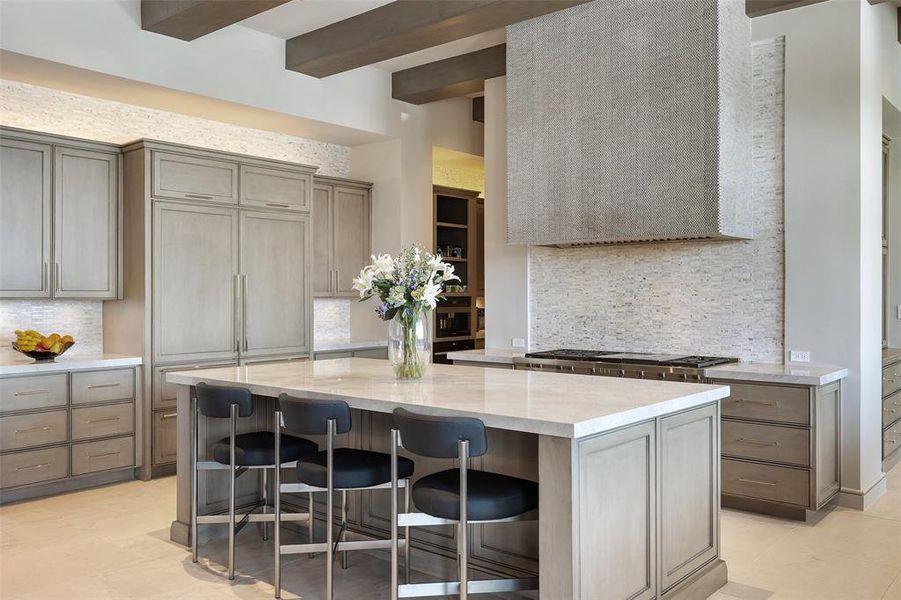 Prepare meals with ease on the luxurious quartz countertops that grace the kitchen, offering both beauty and durability for all your culinary endeavors.