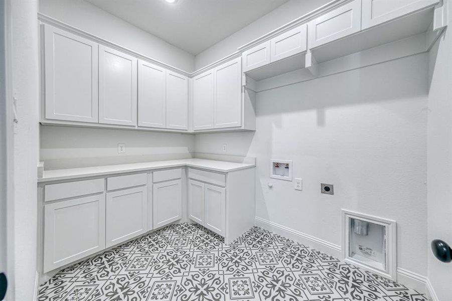 Handy counter space in a dedicated utility room with plenty of cabinet storage.