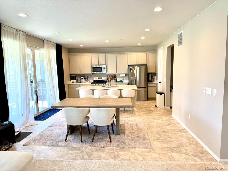 Open kitchen design with floor to ceiling sliding doors