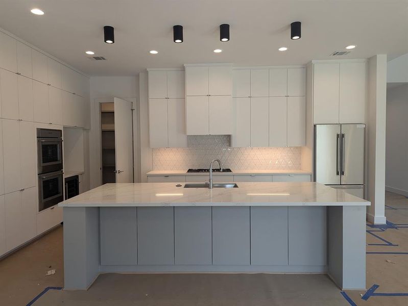 Kitchen island and entry to pantry.