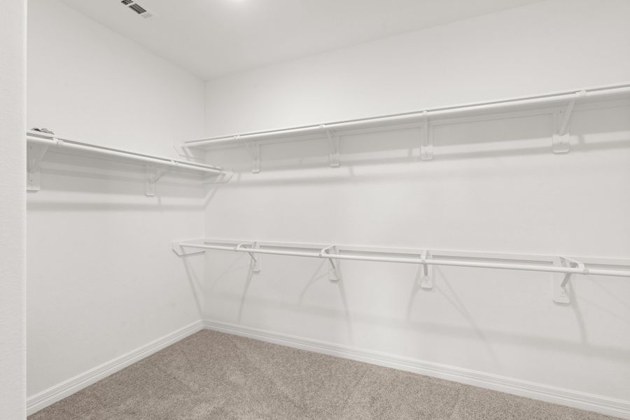 Primary walk in closet. Note: Sample product photo - actual exterior and interior selections may vary by homesite