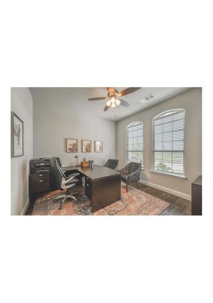 Office area with ceiling fan and hardwood / wood-style floors