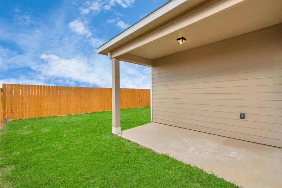 The backyard patio offers a private outdoor space perfect for relaxing or entertaining. Whether you're enjoying a morning coffee or hosting a summer barbecue, this covered area provides the ideal setting. **This image is from another Saratoga Home - Wren floorplan.**