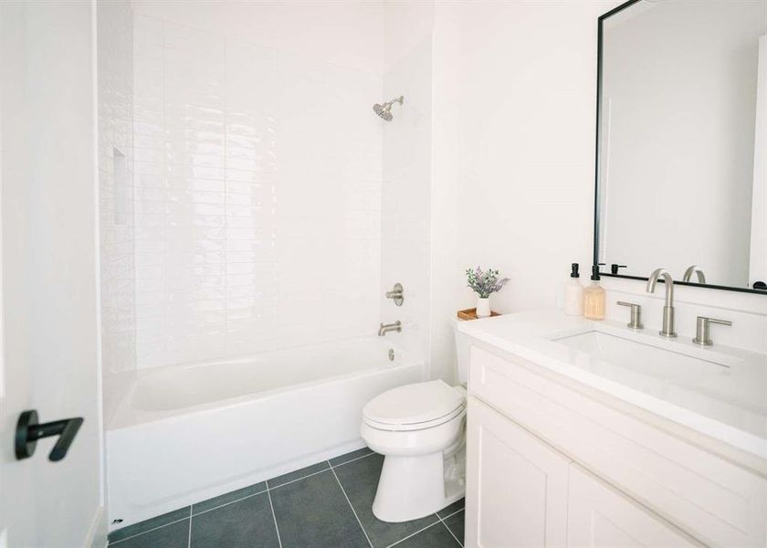 Full bathroom featuring tile flooring, vanity, toilet, and tub / shower combination