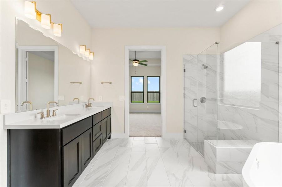 Primary Bathroom with 2 Sinks, Freestanding Tub, and Separate Shower with Seat.