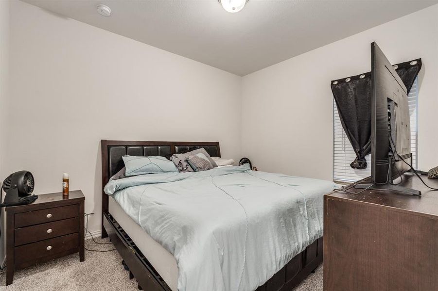 Bedroom featuring light colored carpet