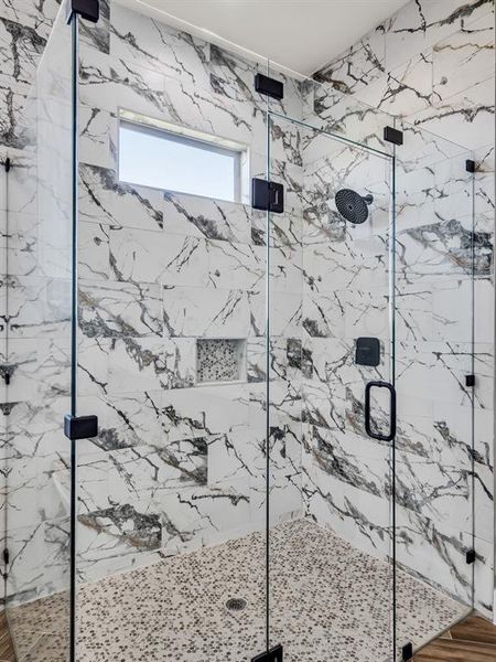 Bathroom with a shower with shower door and wood-type flooring