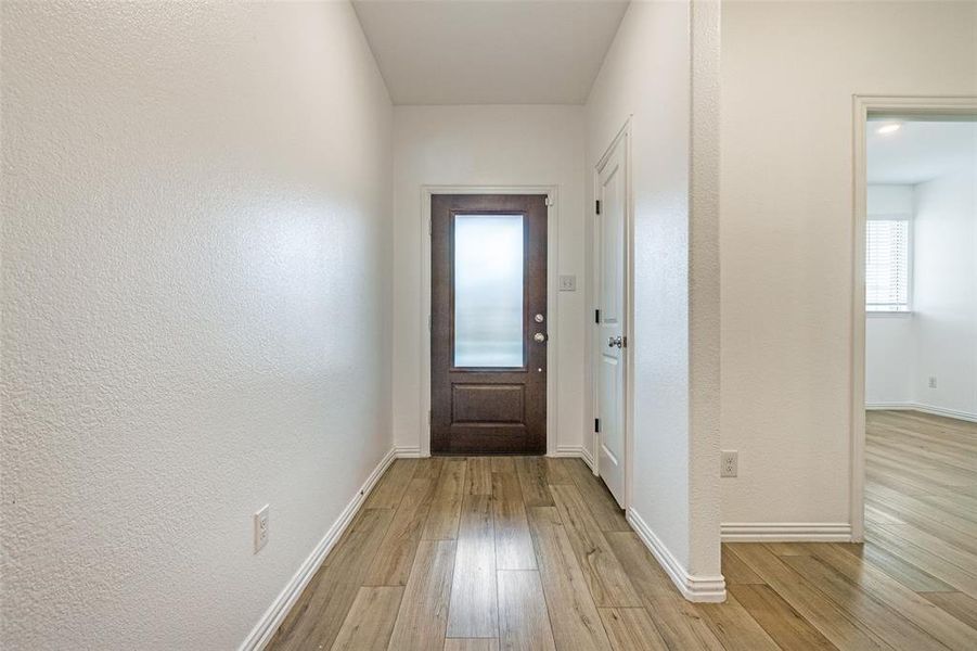 Doorway with light wood-type flooring