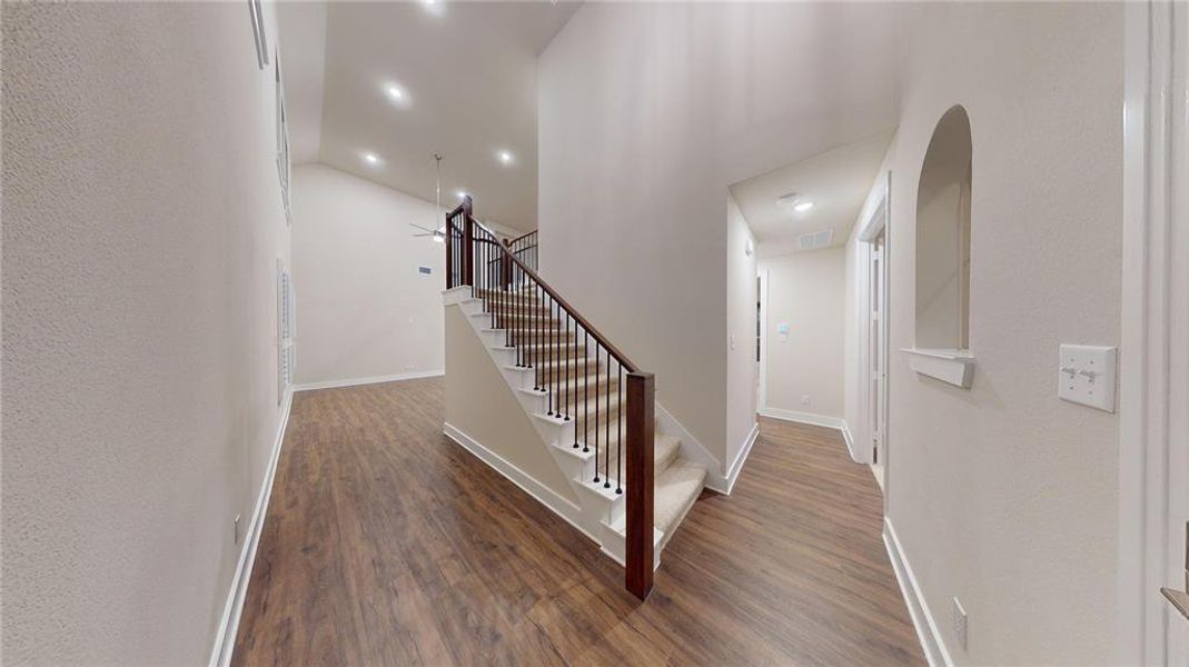 Stairway featuring hardwood / wood-style floors