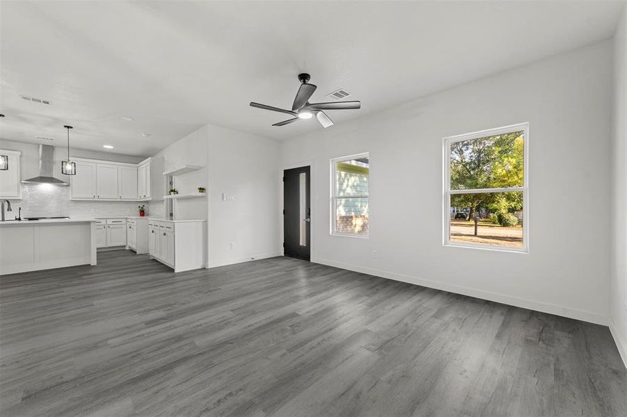 Kitchen with pendant lighting, a center island with sink, stainless steel appliances, and sink