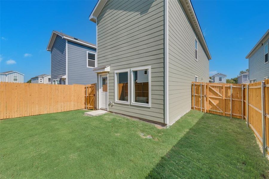 Rear view of house featuring a yard