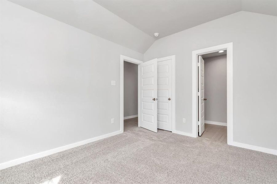 At the forefront of the home, a guest suite with its own bathroom awaits. Sample photo of completed home with similar floor plan. As-built interior colors and selections may vary.