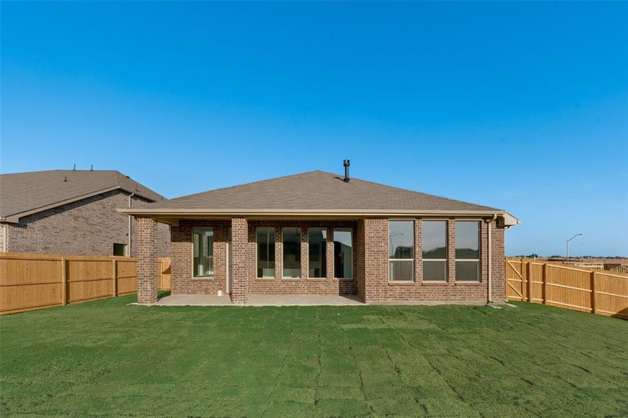 Rear view of house with a patio and a yard