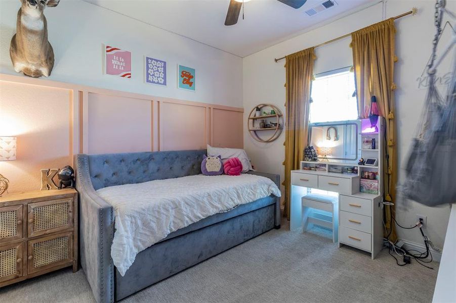 Carpeted bedroom featuring ceiling fan