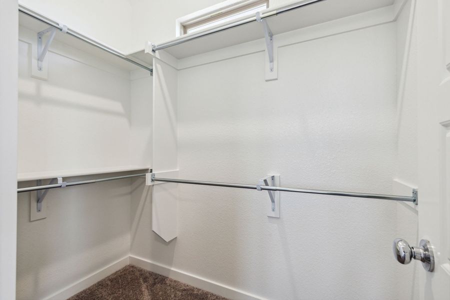 Primary Closet in the Ash home plan by Trophy Signature Homes – REPRESENTATIVE PHOTO