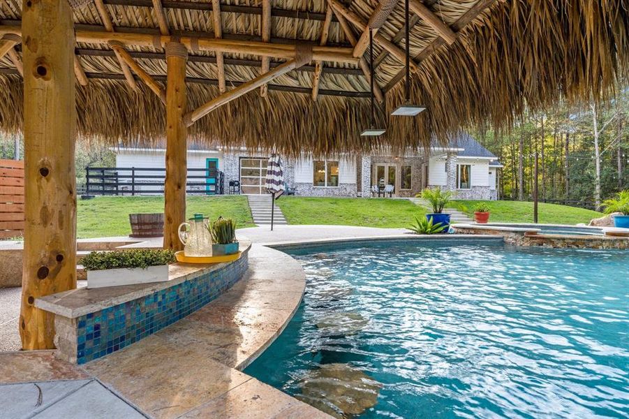 Up the stairs to the left beyond this tiki bar is an enclosed dog run