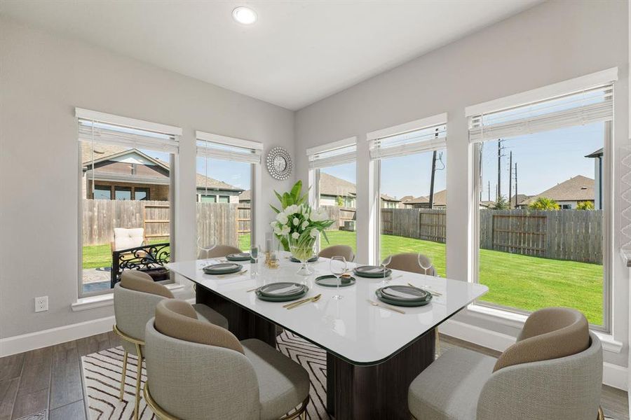 You and your guests will certainly dine in style in this amazing dining room! Featuring large windows with blinds, neutral paint, high ceilings, crown molding, and wood look tile flooring. Perfect space to entertain family and friends.