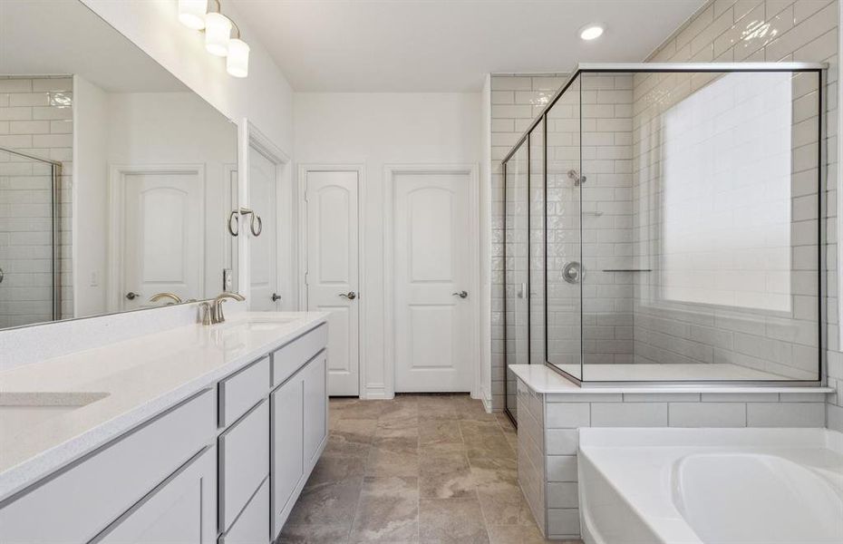 Elegant owner's suite with dual vanity *real home pictured