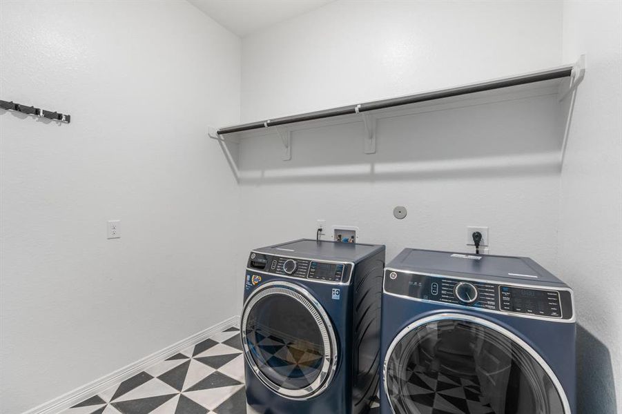 The laundry room features tile floors,washer and dryer connections, andplenty of storage space.