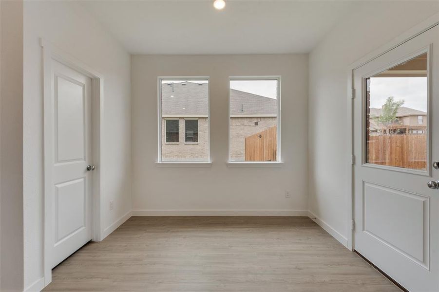 Spare room featuring light hardwood / wood-style floors and a wealth of natural light