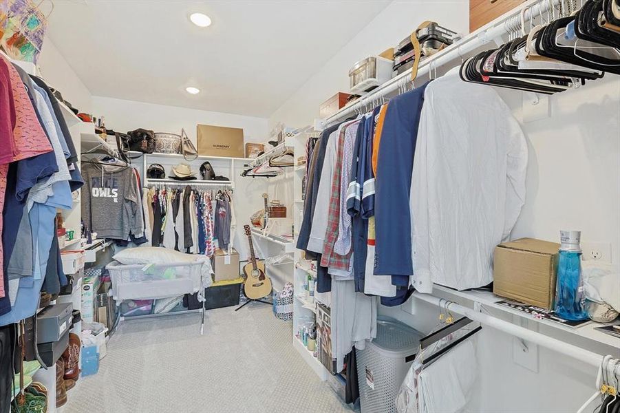 Walk in closet with light carpet