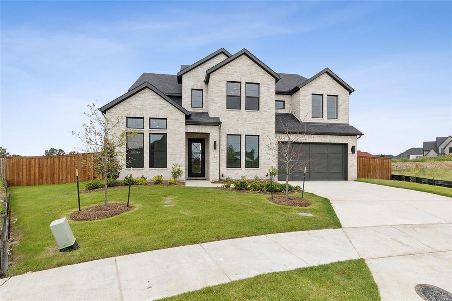 This home offers striking curb appeal with white brick and dark trim!