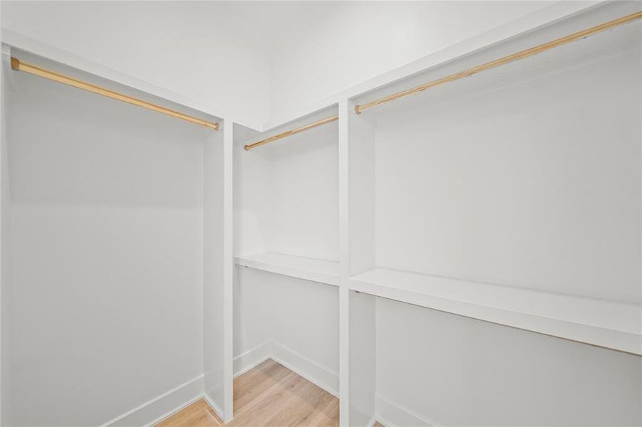 Spacious walk-in closet for the 1st floor bedroom. Photos are from a similar unit in the development.