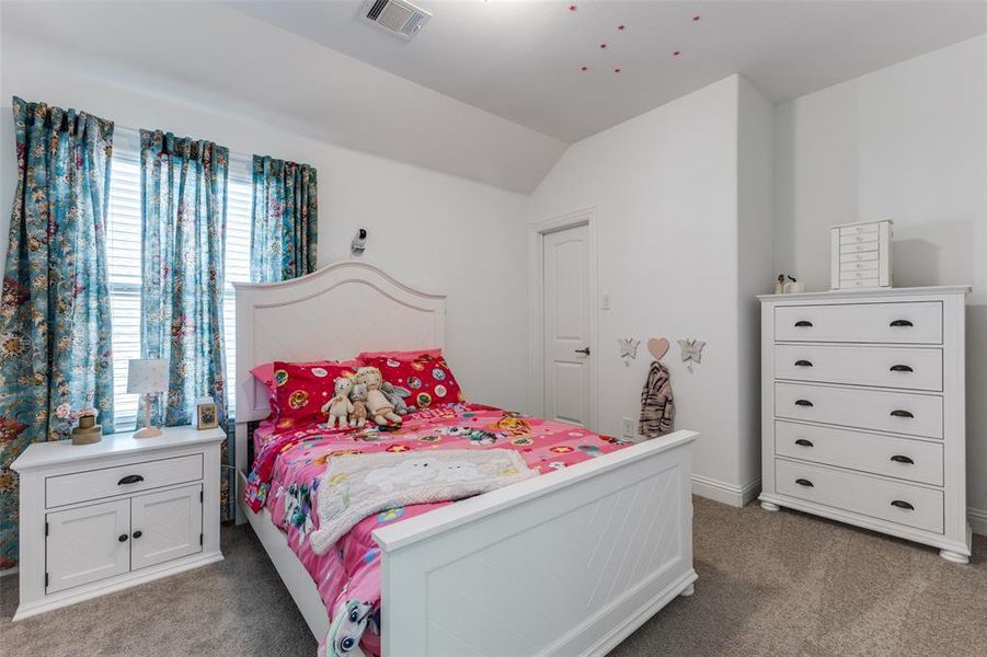 Bedroom featuring vaulted ceiling and carpet floors