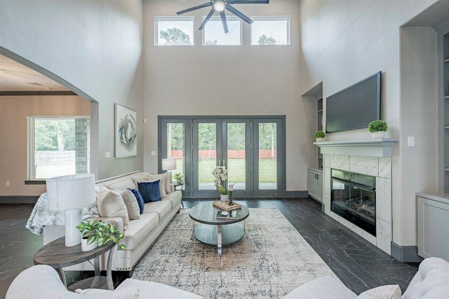 Picturesque living room with dramatic high ceilings and French doors