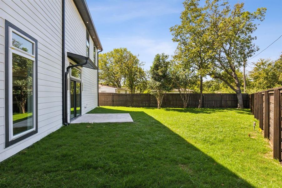 View of yard with a patio area and wood fence